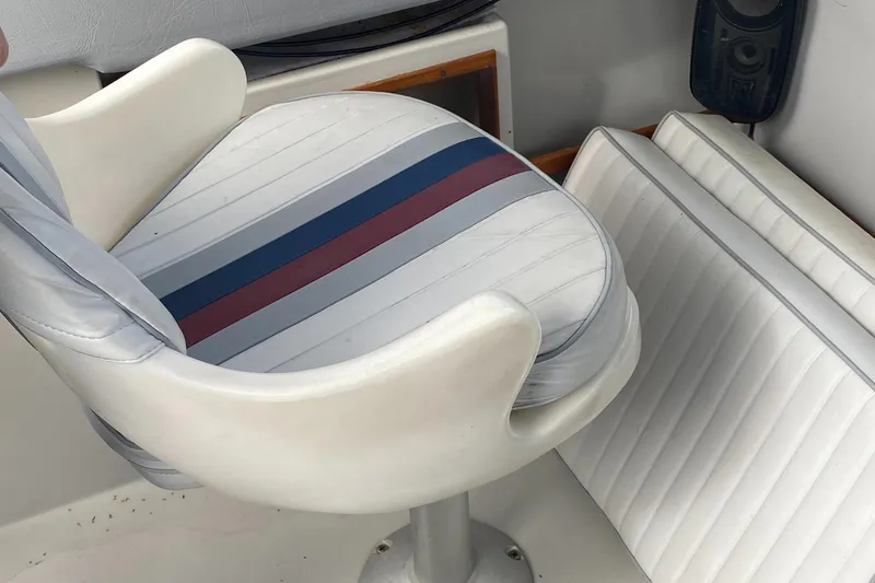 Slide: The Image of 1991 Penn Yan 215 Tempest boat seat with striped upholstery and white cushions. - 7