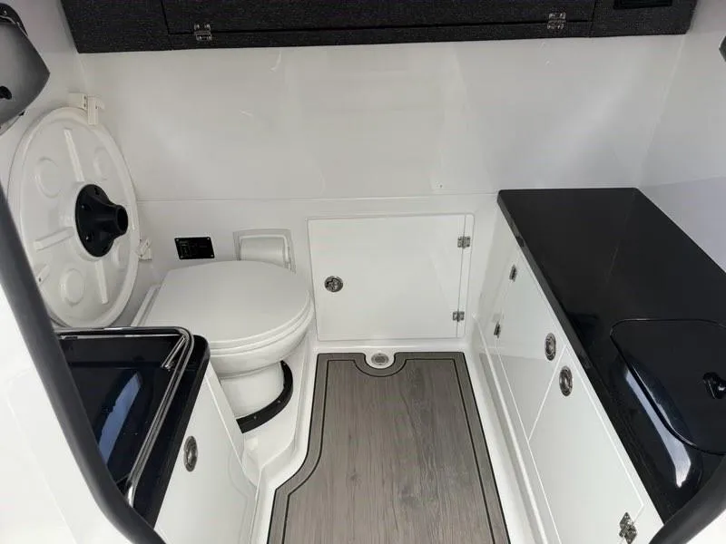 Slide: The Image of 2025 Monterey Elite 30 OB boat interior with modern bathroom amenities. - 13