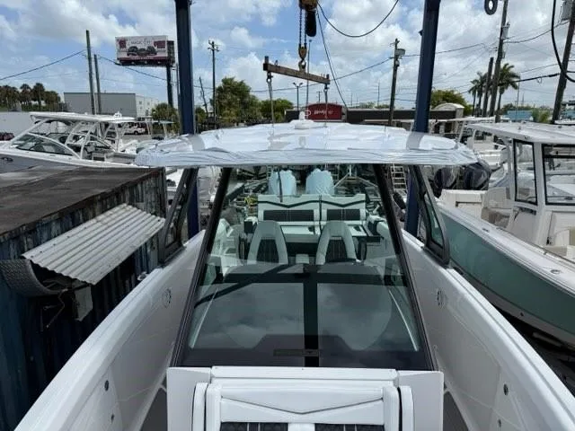 Slide: The Image of 2025 Monterey Elite 30 OB boat, docked with clear skies and surrounding vessels. - 4