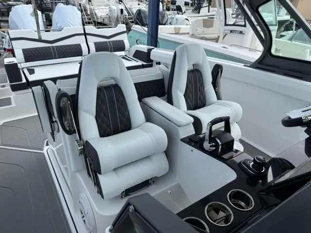 Slide: The Image of 2025 Monterey Elite 30 OB boat interior with luxurious seating and modern controls. - 6
