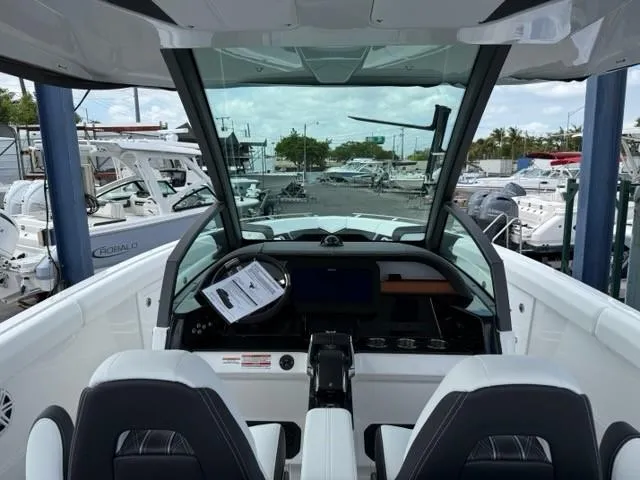 Slide: The Image of 2025 Monterey Elite 30 OB boat interior with modern dashboard and dual seating. - 7