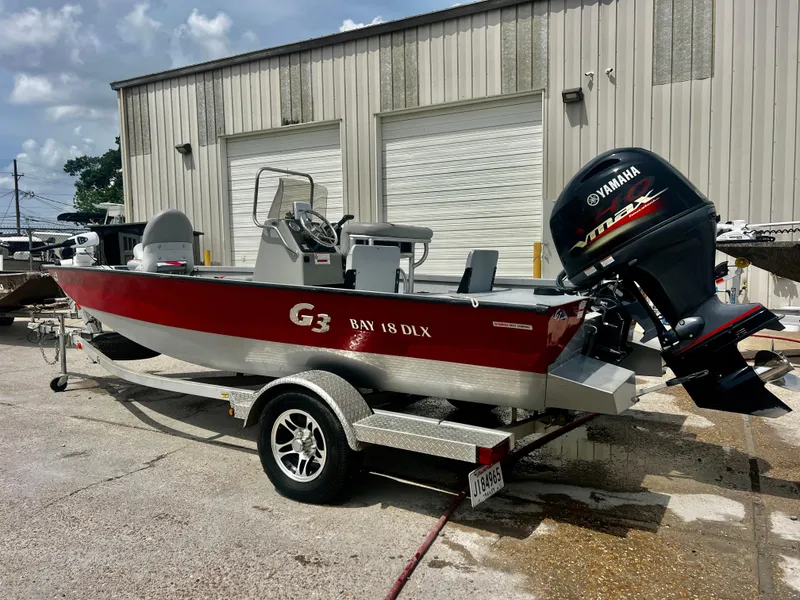 Slide: The Image of 2018 G3 Bay 18 DLX boat with Yamaha outboard motor on trailer. - 1