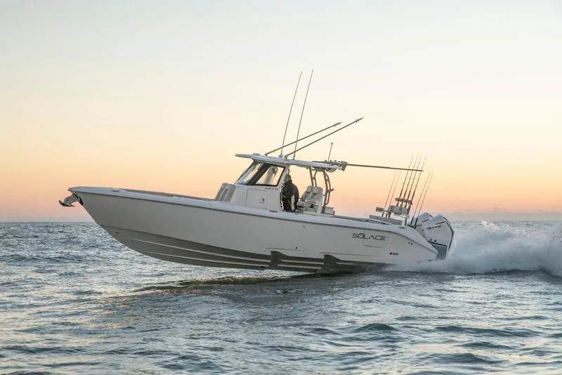 Slide: The Image of 2025 Solace 32 CS boat cruising on ocean at sunset. - 3