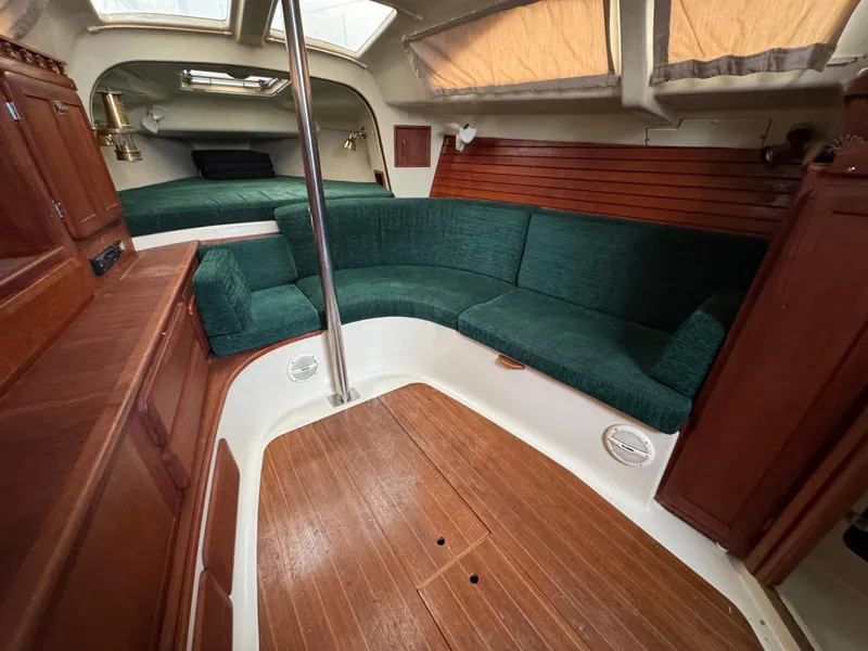 Slide: The Image of Interior of 1994 Hunter 29.5 sailboat with green seating and wood accents. - 12