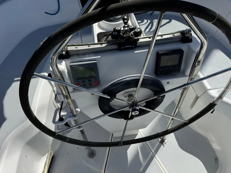 Slide: The Image of Steering wheel and controls of a 1994 Hunter 29.5 sailboat cockpit. - 15