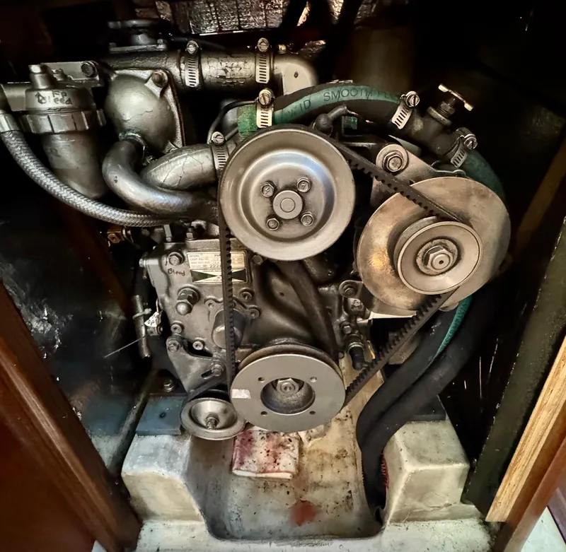 Slide: The Image of Engine of a 1994 Hunter 29.5 sailboat, showcasing belts and pulleys. - 16