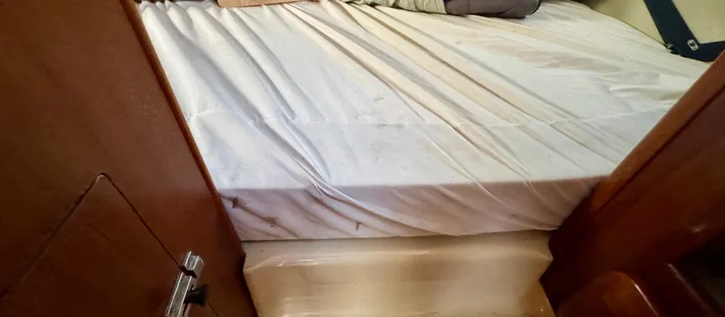 Slide: The Image of Interior cabin of 1994 Hunter 29.5 sailboat with bed and wooden paneling. - 18