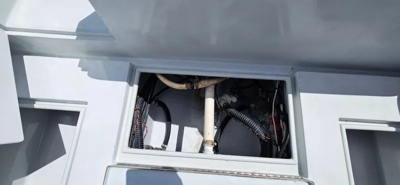 Slide: The Image of 2002 Contender 23 Open boat wiring and plumbing compartment. - 13