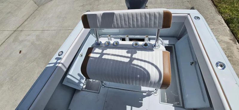 Slide: The Image of 2002 Contender 23 Open boat interior with white and brown seating. - 14