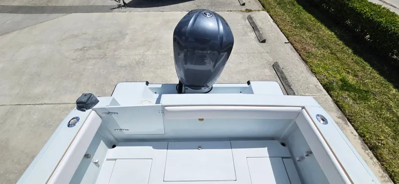 Slide: The Image of 2002 Contender 23 Open boat with outboard motor, viewed from above on concrete surface. - 17