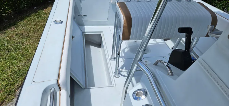 Slide: The Image of 2002 Contender 23 Open boat interior with storage compartment and seating. - 19
