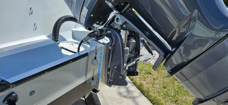 Slide: The Image of Outboard motor on a 2002 Contender 23 Open boat, showing engine mount and hydraulic system. - 2