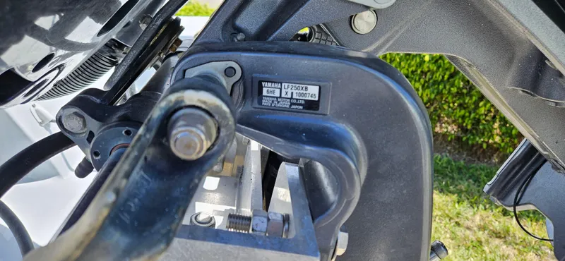 Slide: The Image of Close-up of a Yamaha outboard motor part on a 2002 Contender 23 Open boat. - 22