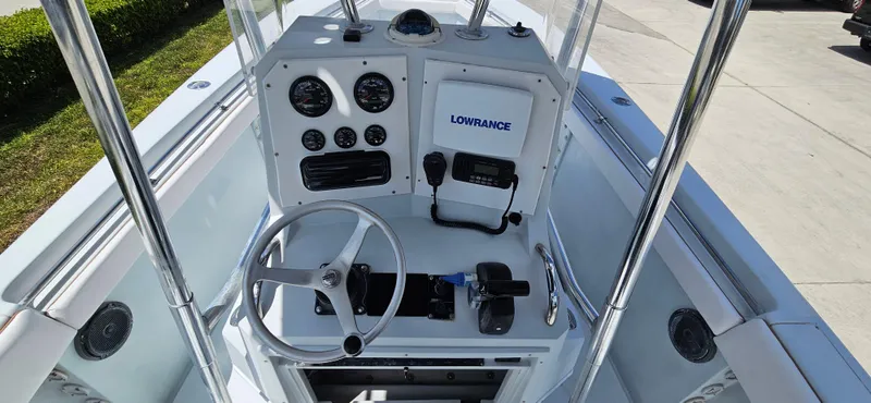 Slide: The Image of 2002 Contender 23 Open boat console with steering wheel and navigation instruments. - 3
