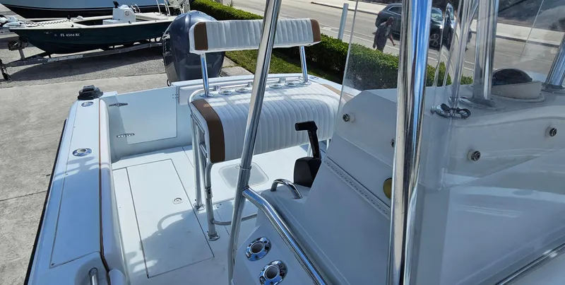 Slide: The Image of 2002 Contender 23 Open boat interior with seating and console, docked outdoors. - 4