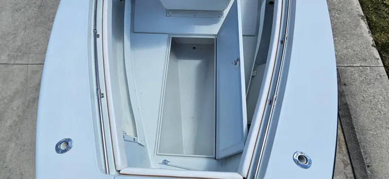 Slide: The Image of 2002 Contender 23 Open boat interior, showcasing storage compartments and sleek design. - 9