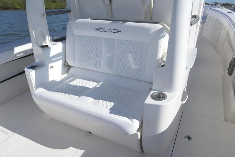 Slide: The Image of Luxury seating on 2025 Solace 37 CS boat, featuring elegant white upholstery and cup holders. - 12