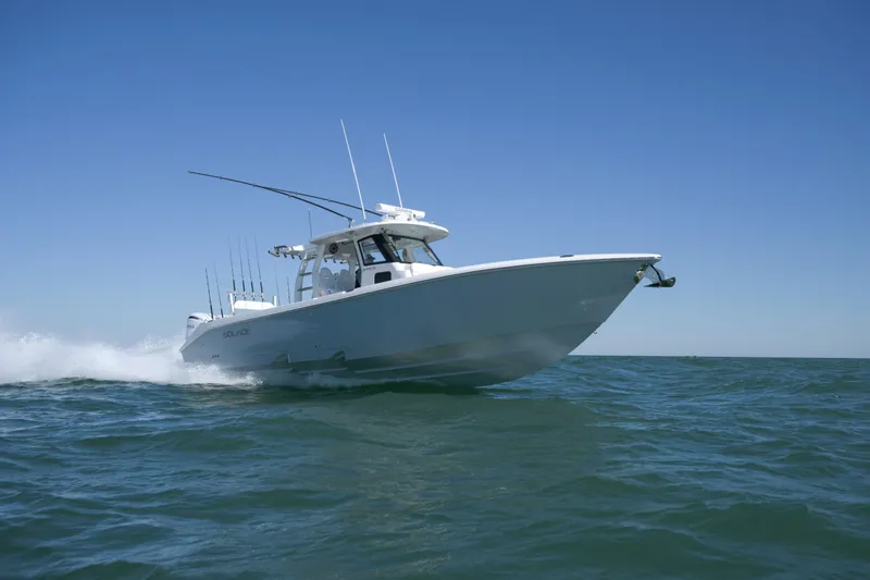 Slide: The Image of 2025 Solace 37 CS boat cruising on open water under clear blue sky. - 2