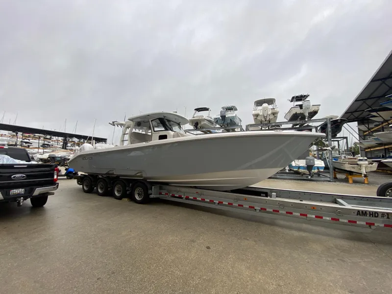 Slide: The Image of 2025 Solace 37 CS boat on trailer at marina, overcast sky. - 20