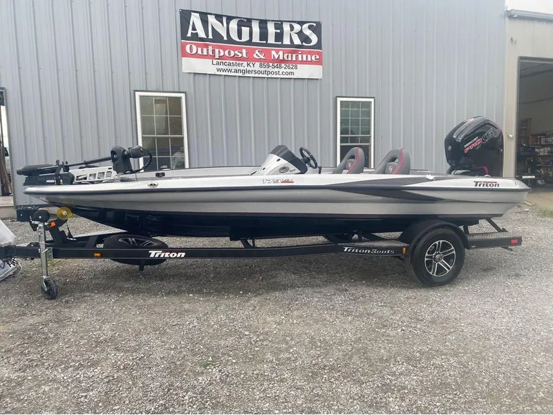 Slide: The Image of 2024 Triton 179 TrX boat on trailer outside Anglers Outpost & Marine. - 1