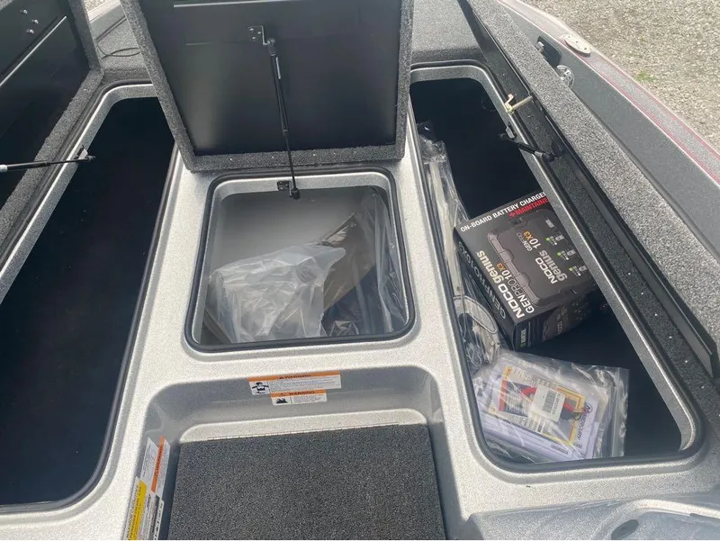 Slide: The Image of 2024 Triton 179 TrX storage compartments with onboard battery charger and accessories. - 7
