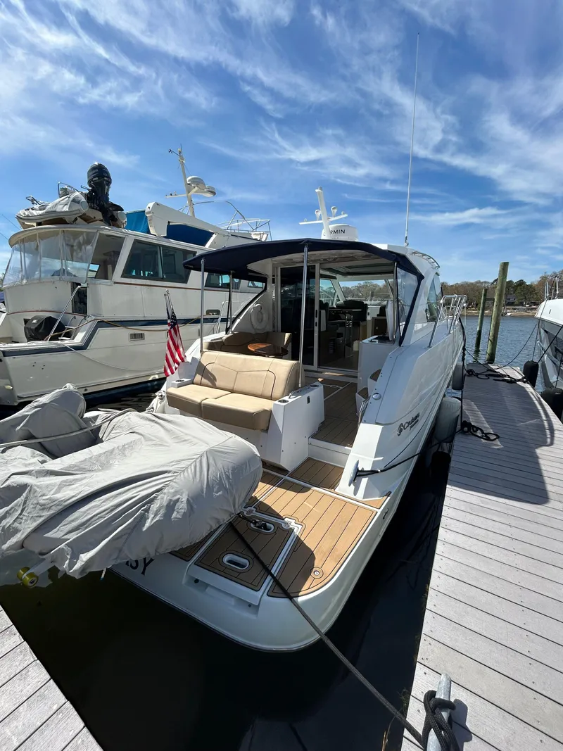 Slide: The Image of 2014 Cruisers Yachts 41 Cantius docked, featuring spacious deck and modern design. - 3