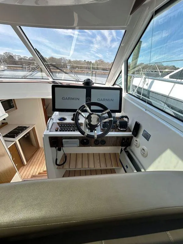 Slide: The Image of 2014 Cruisers Yachts 41 Cantius helm with Garmin navigation displays and steering wheel. - 9