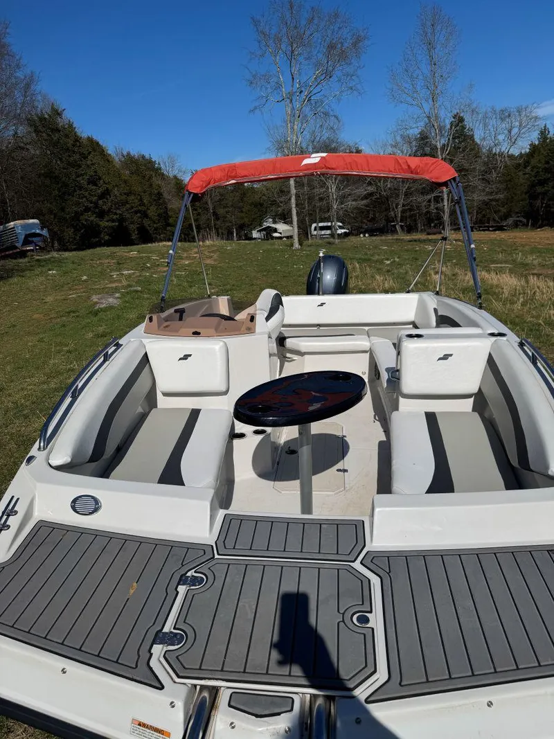 Slide: The Image of 2022 Starcraft SVX 171 OB boat with red canopy, spacious seating, and modern design. - 5