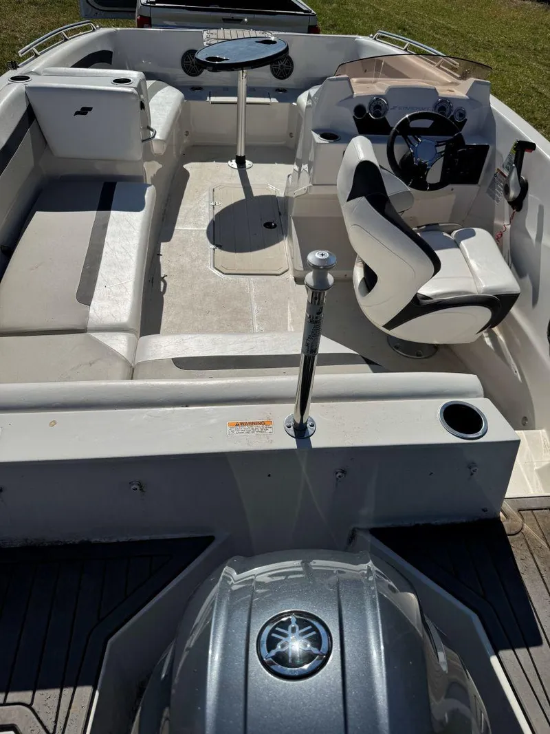 Slide: The Image of 2022 Starcraft SVX 171 OB boat interior with seating, steering wheel, and table. - 6