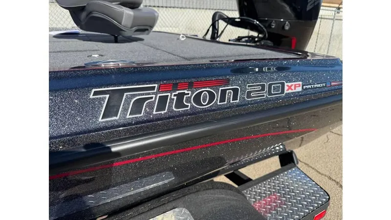 Slide: The Image of 2025 Triton 20XP Patriot boat, close-up of logo and deck, showcasing sleek design. - 7