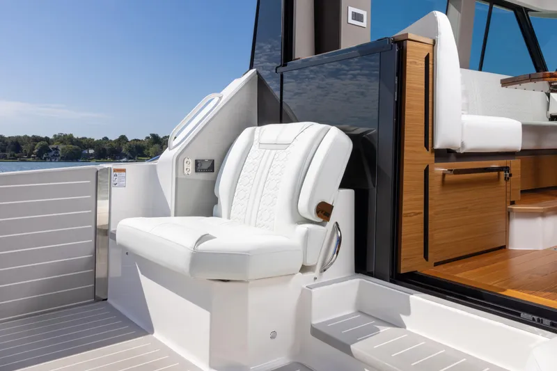 Slide: The Image of 2025 Tiara Yachts 43 LE interior with white seating and wooden accents. - 12
