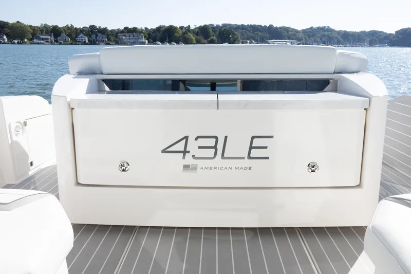 Slide: The Image of 2025 Tiara Yachts 43 LE boat, American-made, on water with scenic background. - 8