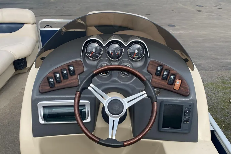 Slide: The Image of Steering console of a 2014 Godfrey 22 PF boat with gauges and controls. - 4