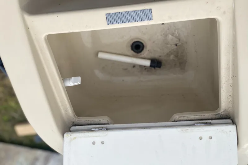 Slide: The Image of Open storage compartment in a 2014 Godfrey 22 PF boat, showing interior details. - 6