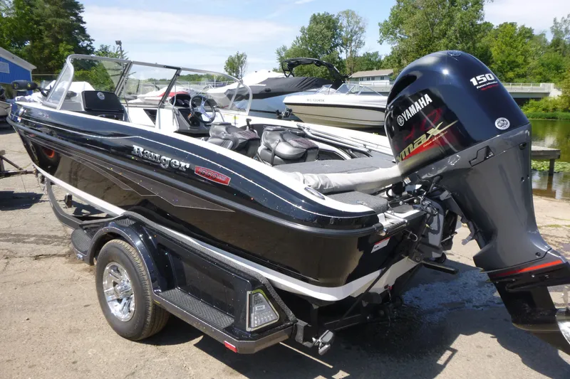 Slide: The Image of 2024 Ranger 1850MS boat with Yamaha engine, parked outdoors on a sunny day. - 15