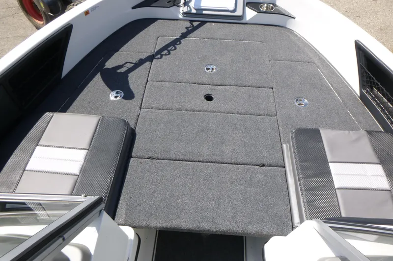 Slide: The Image of 2024 Ranger 1850MS boat interior with gray carpeted deck and seating. - 25