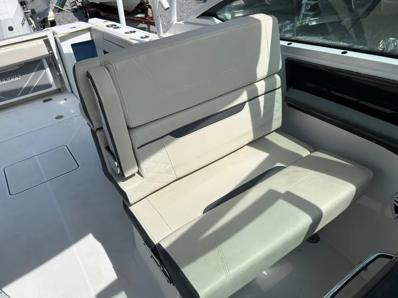 Slide: The Image of 2023 Blackfin 272 DC boat interior seating with light upholstery and modern design. - 11