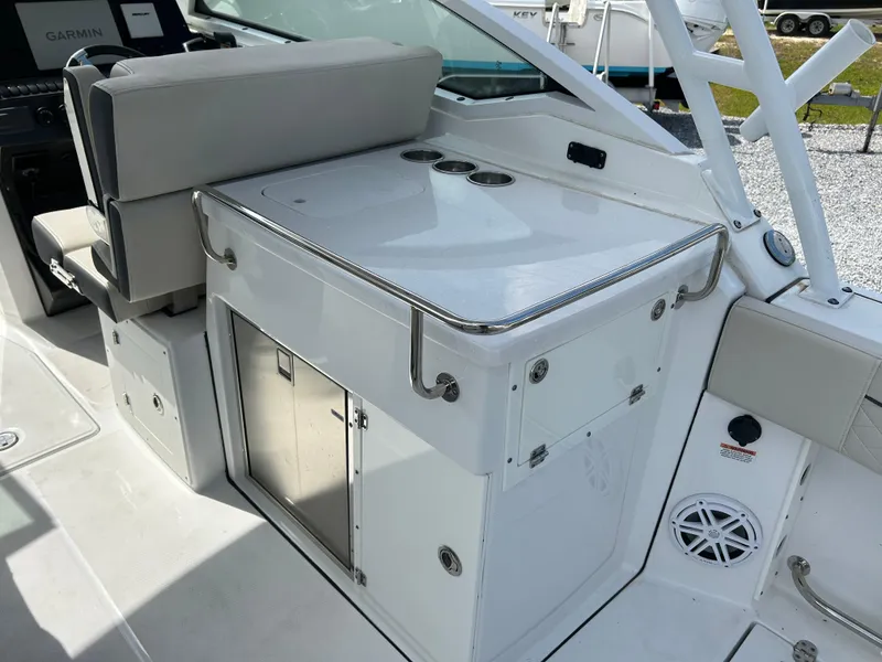 Slide: The Image of 2023 Blackfin 272 DC boat interior with seating and storage area. - 13