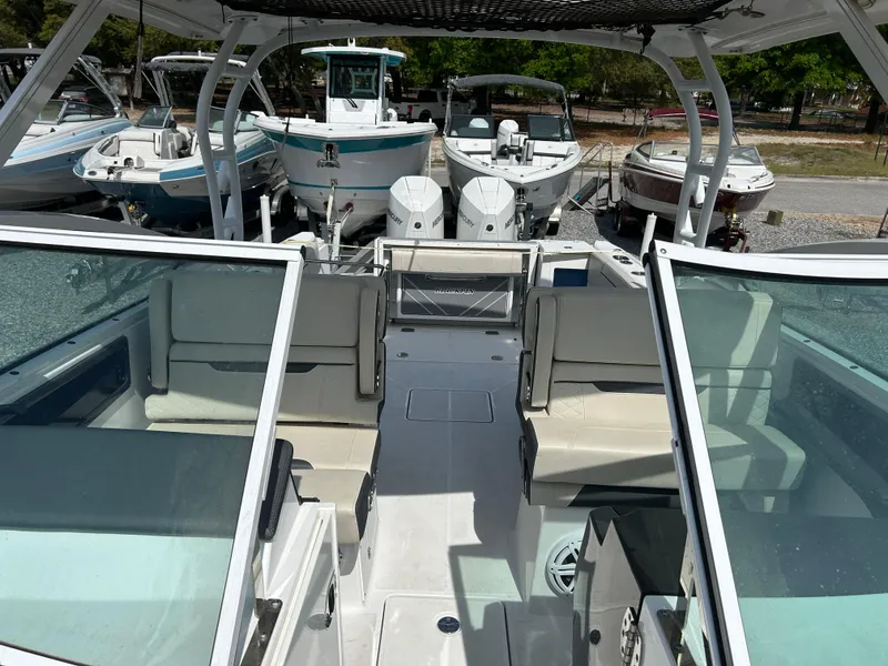 Slide: The Image of 2023 Blackfin 272 DC boat interior with seating and dual outboard engines. - 6