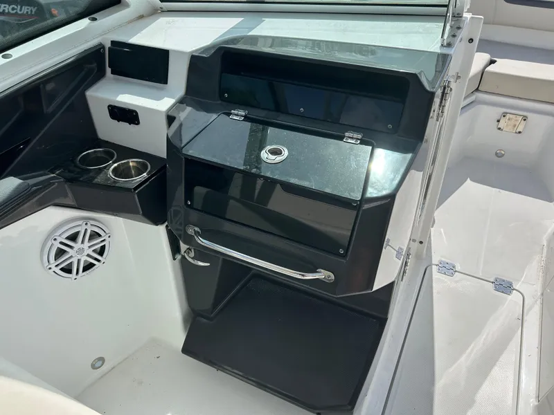 Slide: The Image of 2023 Blackfin 272 DC boat interior with sleek dashboard and cup holders. - 9