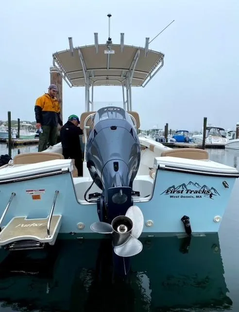 Slide: The Image of 2018 Parker 21SE Center Console boat docked, featuring outboard motor and canopy. - 1