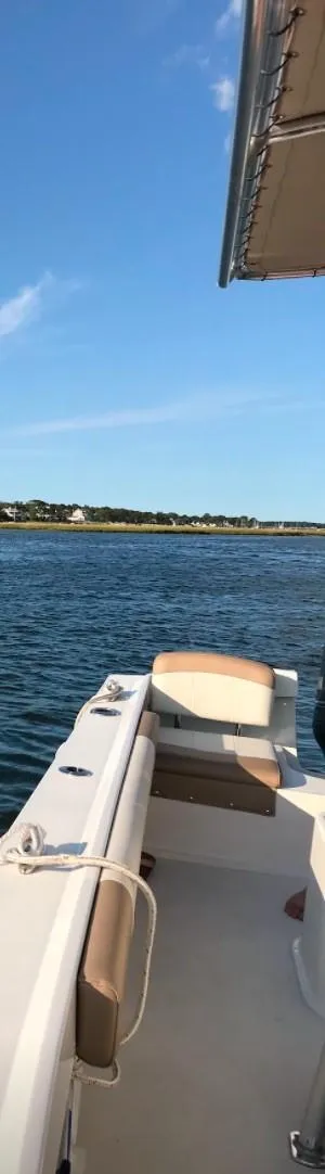 Slide: The Image of 2018 Parker 21SE Center Console boat on calm water under clear blue sky. - 11