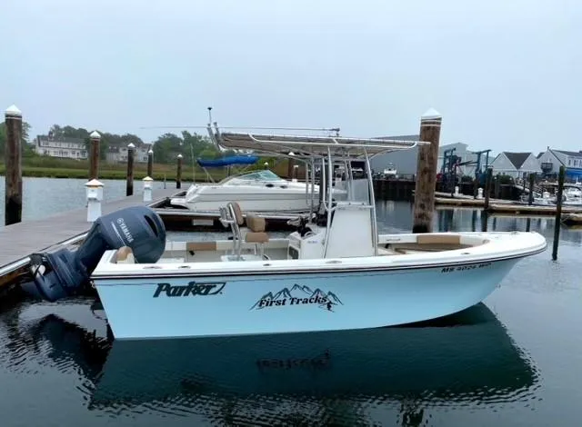 Slide: The Image of 2018 Parker 21SE Center Console boat docked at marina, featuring Yamaha outboard motor. - 2