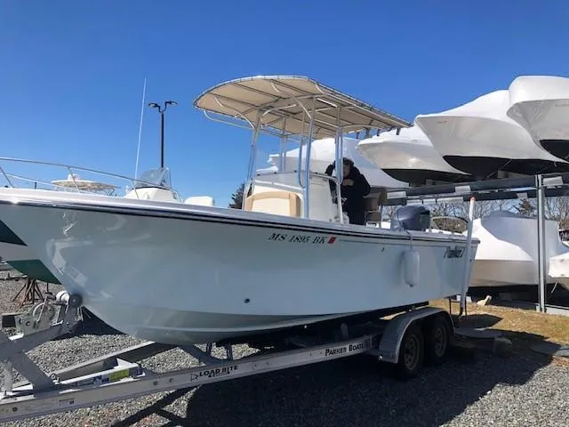 Slide: The Image of 2018 Parker 21SE Center Console boat docked on calm water, scenic background. - 4