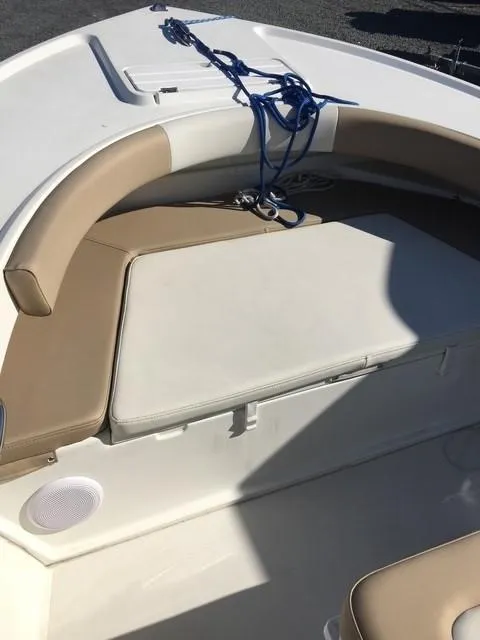 Slide: The Image of 2018 Parker 21SE Center Console boat with cushioned seating and blue rope. - 7