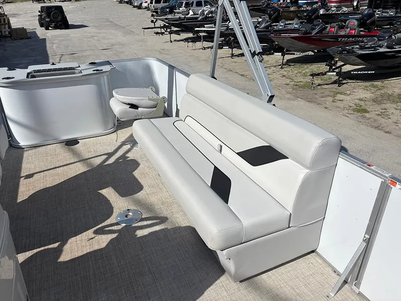 Slide: The Image of 2023 SunCatcher Select 18F pontoon boat interior with beige seating and helm. - 11