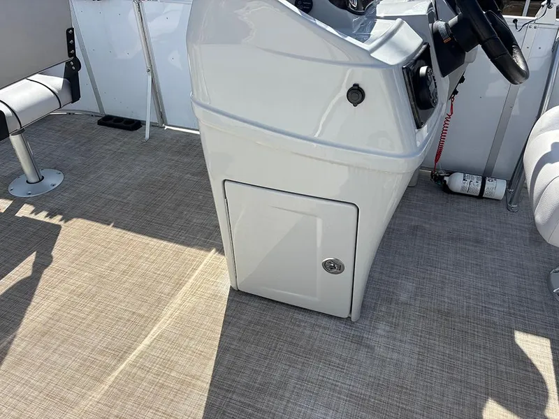 Slide: The Image of 2023 SunCatcher Select 18F boat console with steering wheel and storage compartment. - 13