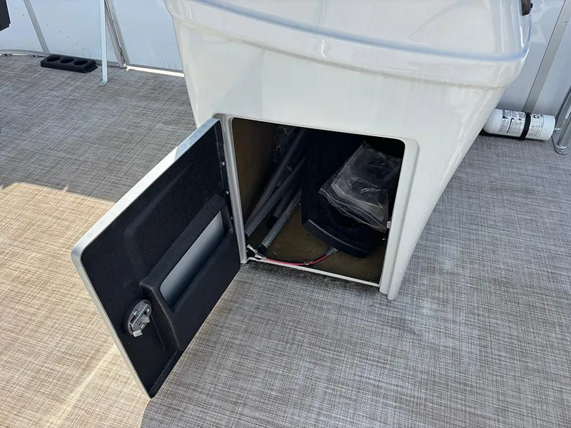 Slide: The Image of Open storage compartment on 2023 SunCatcher Select 18F boat, showing interior details. - 14