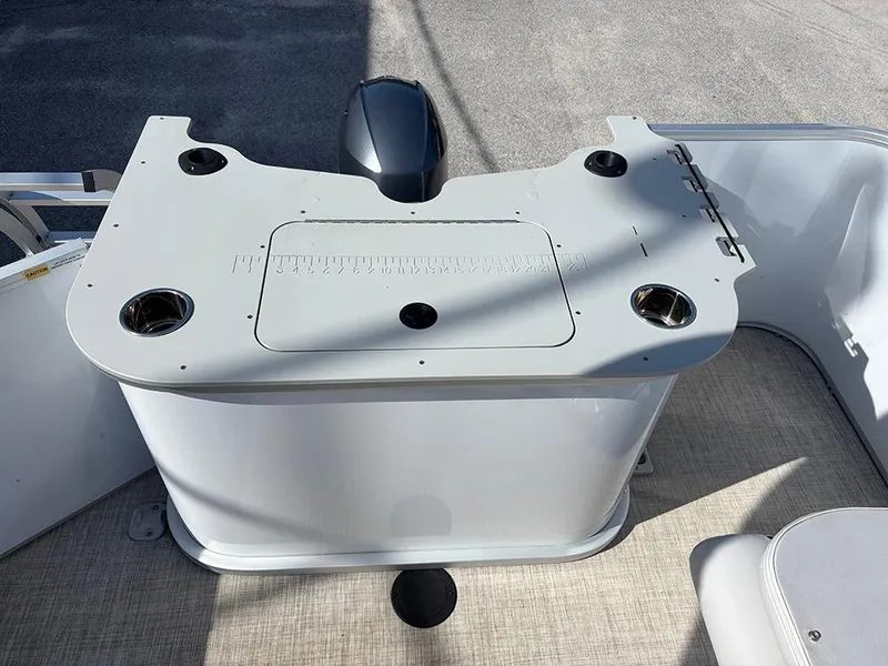 Slide: The Image of 2023 SunCatcher Select 18F boat console with cup holders and storage compartment. - 16