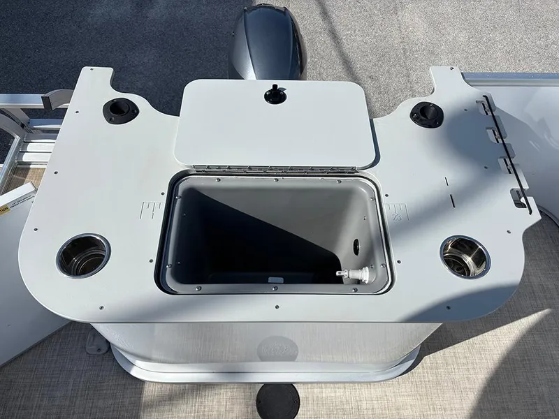 Slide: The Image of 2023 SunCatcher Select 18F boat console with storage compartment and cup holders. - 17